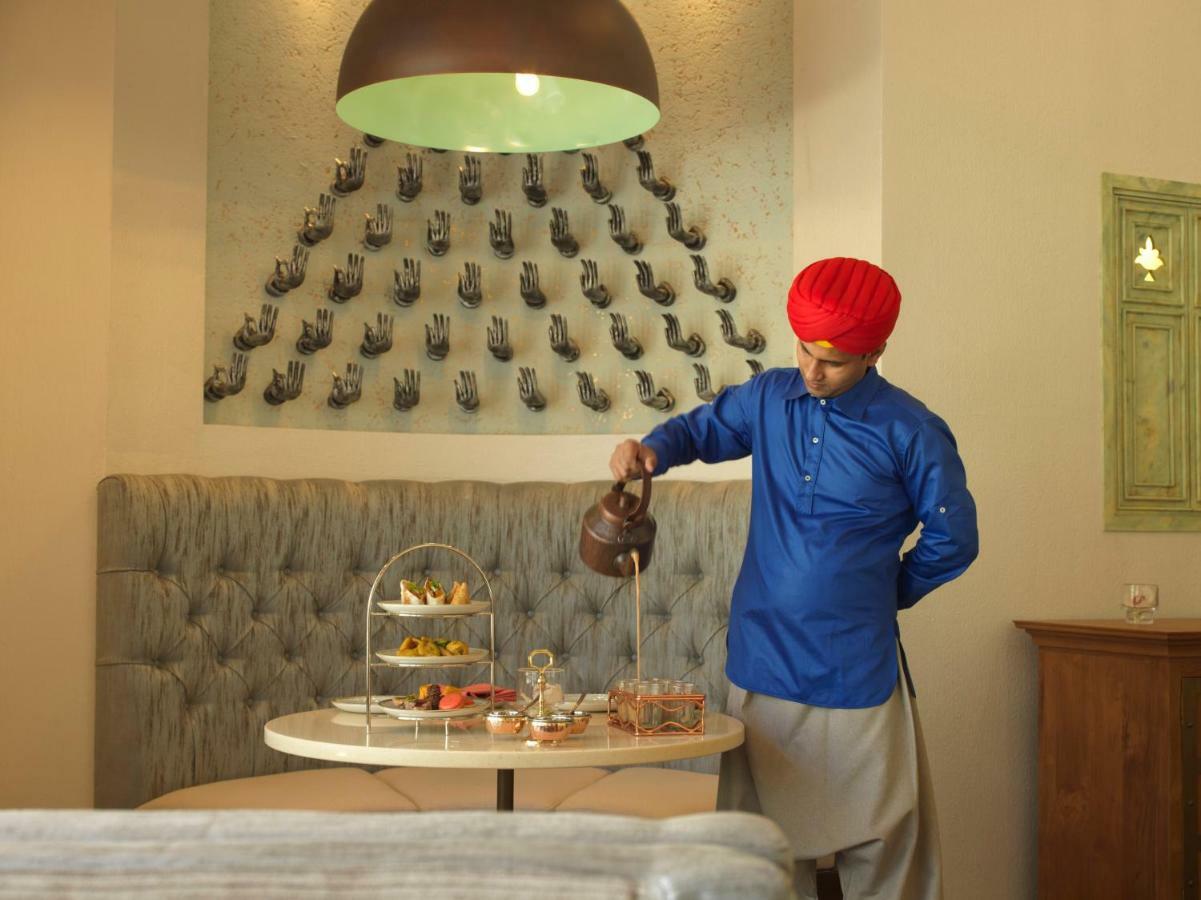Kempinski Hotel Muscat Exterior photo A butler serving tea at a hotel